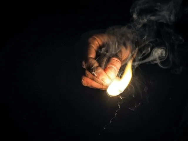 pexels-energepiccom-426444 Hand holding a lit match illustrating the risk of serious burn injuries