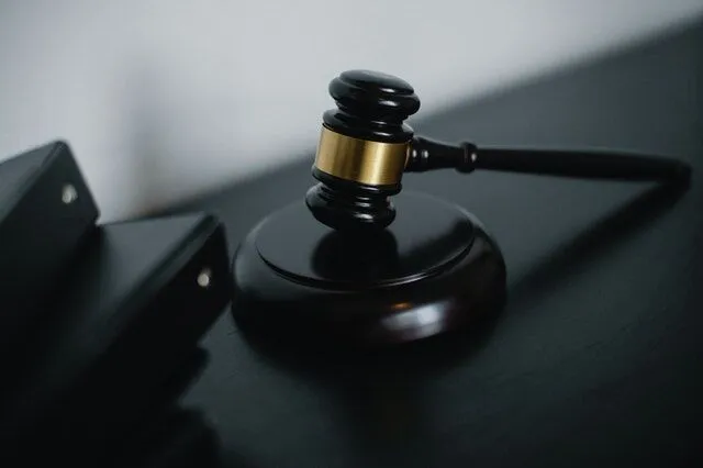 pexels-sora-shimazaki-5668473 Judge's gavel on a dark wooden surface in a courtroom
