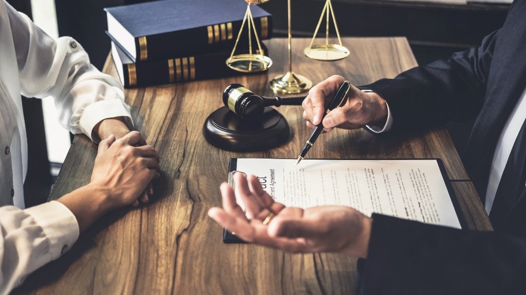 Slip And Fall Lawyer Reviewing Injury Claim With Client