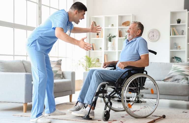 Angry Caregiver Speaking To Elderly Nursing Home Resident