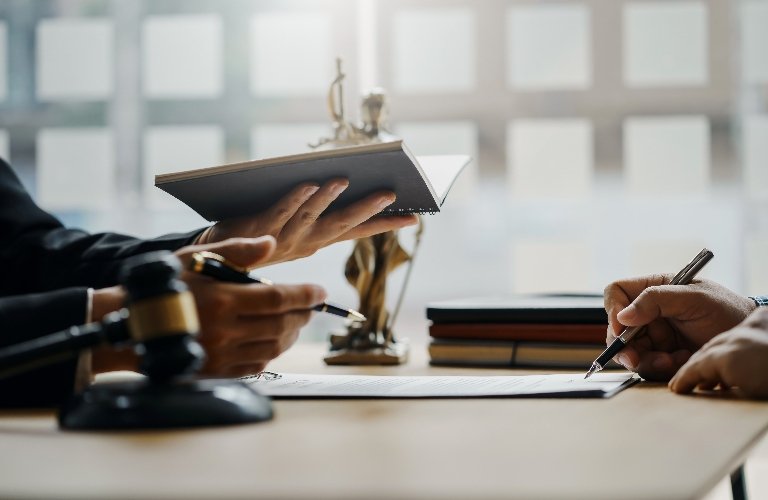 Personal Injury Lawyer Reviewing Insurance Claim Denial With Client