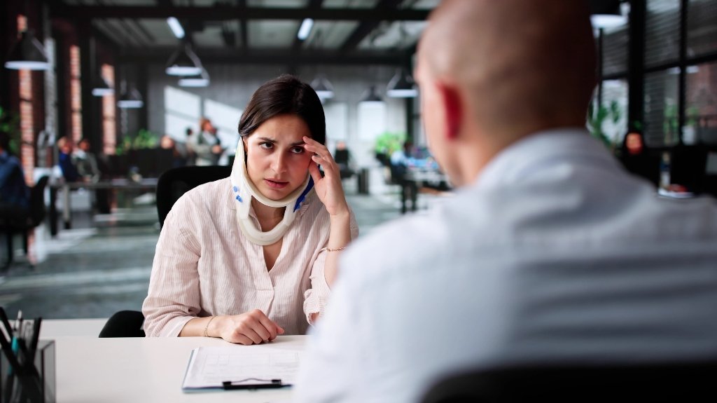 Woman with personal injury is consulting with lawyer_s Woman with personal injury is consulting with lawyer